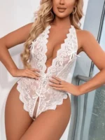 Detailed close-up showing the scalloped floral lace trim and soft mesh texture used in the lower part of the teddy.