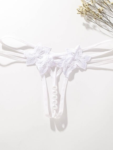 White floral lace pearl open crotch strappy thong panty flat lay