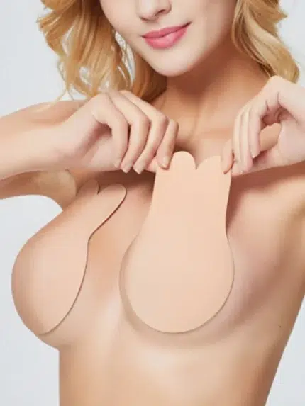Nude silicone breast lift covers being applied on skin