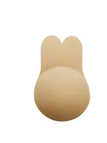 Lifestyle image showing a model applying nude silicone breast lift covers designed for lift, support, and a seamless look under clothing.