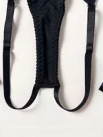 Black thong detail with attached garter straps from sexy cut out lingerie set