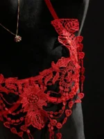 Close-up of red floral embroidery bra detail with sheer cup and lace appliqué