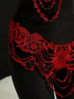 Close-up of red floral embroidery thong detail with draped decorative accents
